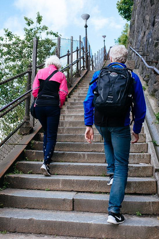 An elderly couple walking up the stairs near Stadsgårdshissen in the Katarina-Sofia area in Stockholm.