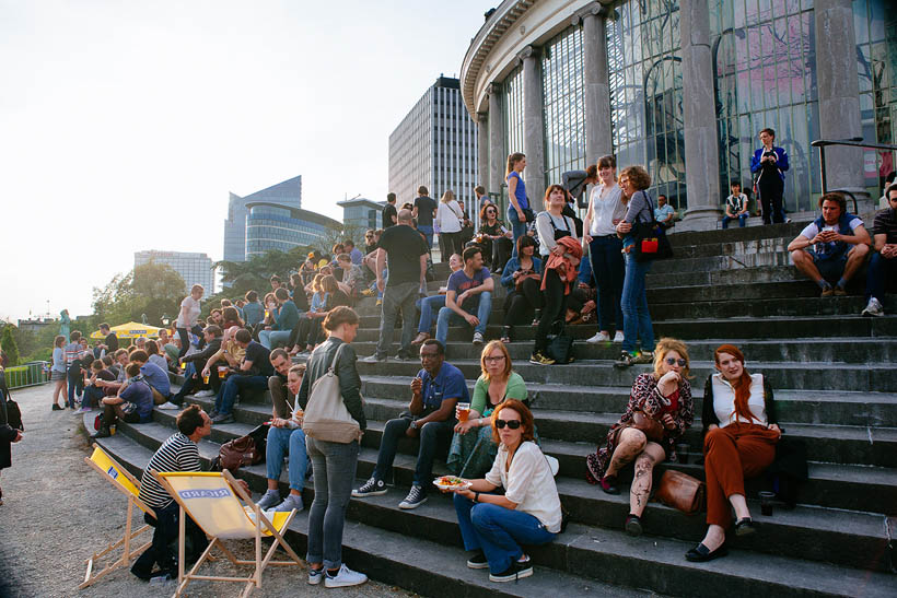 Concertgoers relaxing in the gardens of the Botanique in Brussels during Les Nuits Botanique.